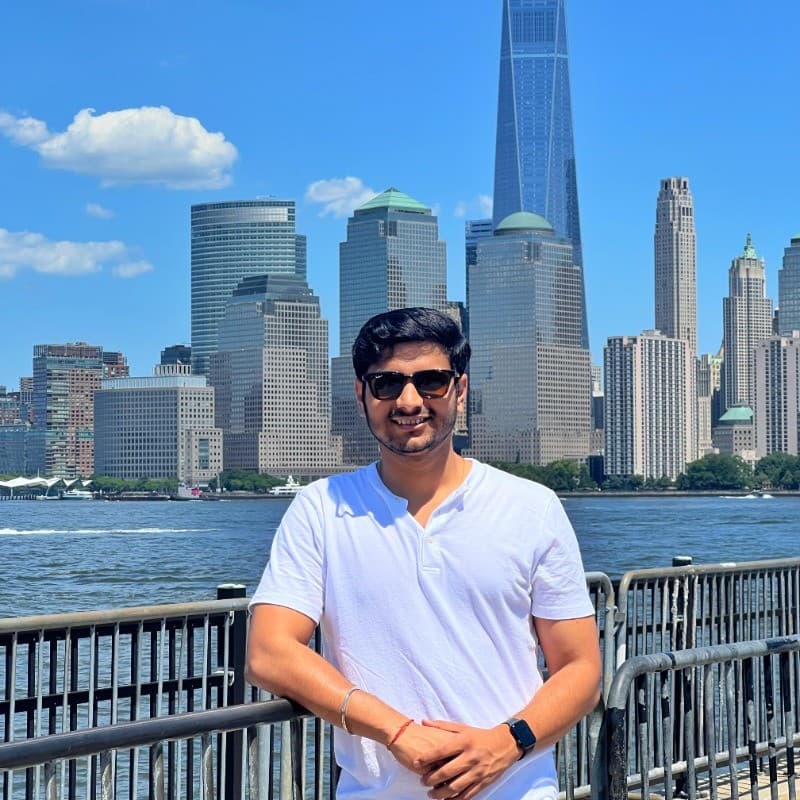 Suraj Sah in front of the Lower Manhattan skyline